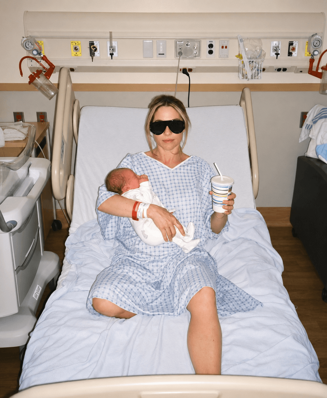 New mama in hospital gown holding her newborn